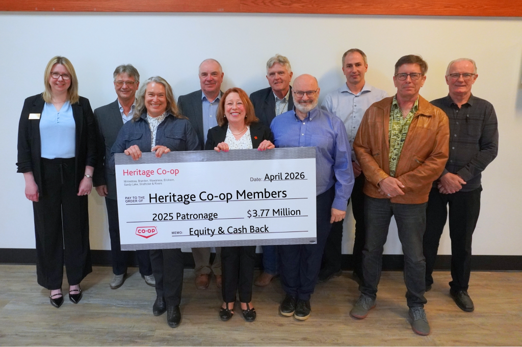 Board and CEO hold a cheque announcing $3.77M in patronage